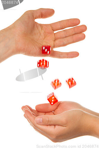 Image of Five red dice being thrown from a hand