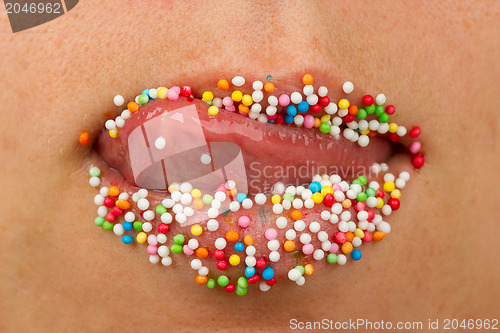 Image of Woman lips with multicolored pearls 