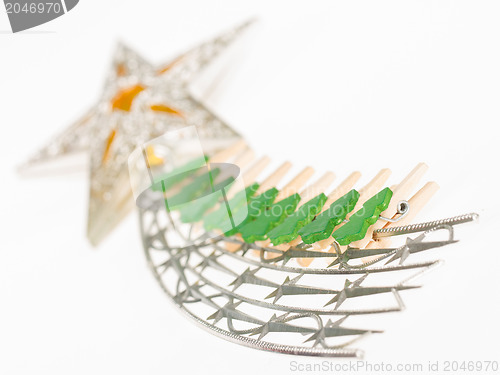 Image of Falling star, christmas decoration with small clothing pins isol