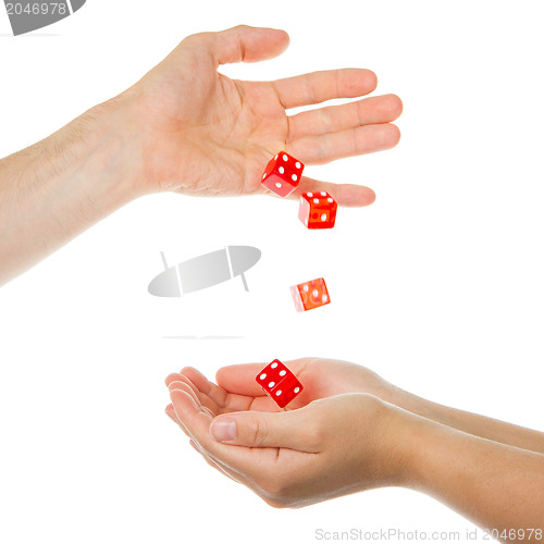 Image of Five red dice being thrown from a hand