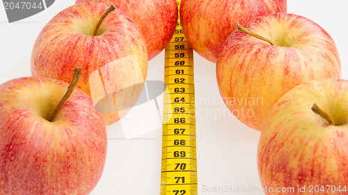 Image of Red apples with a yellow tape-measure