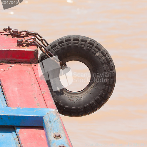 Image of Fender on a red boat in the Mekong delta