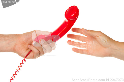 Image of Man giving red telephone to woman