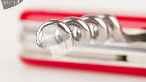 Image of Red swiss army knife isolated, focus on corkscrew