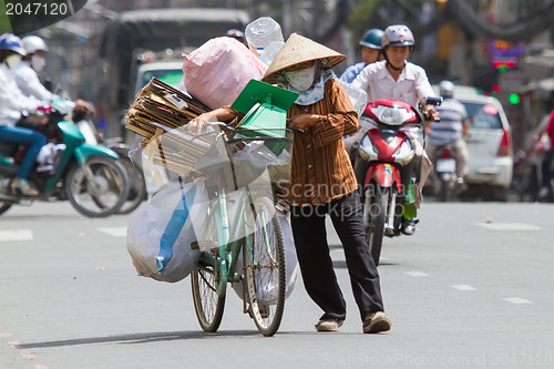 Image of HUE, VIETNAM - JULY 25. Vietnamese woman packed her possesions o