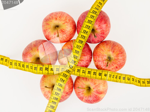 Image of Red apples with a yellow tape-measure