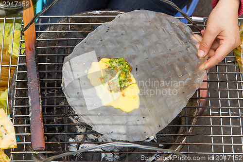 Image of Rice paper meal being made on a barbeque