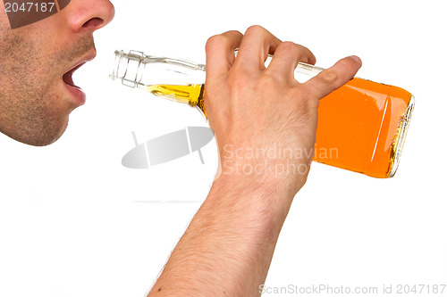 Image of Man drinking alcohol out of a bottle