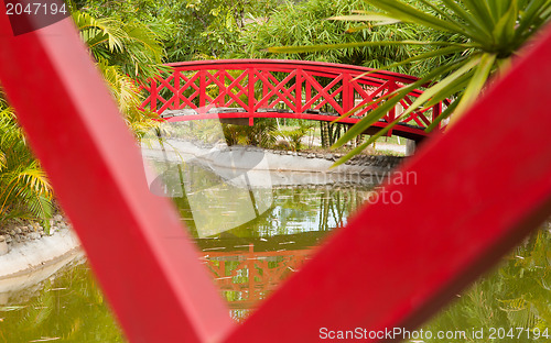 Image of Red bridge over water in a Japanese garden