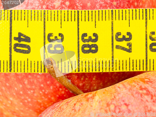 Image of Red apples with a yellow tape-measure