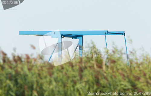 Image of Blue drawbridge hidden in the reeds
