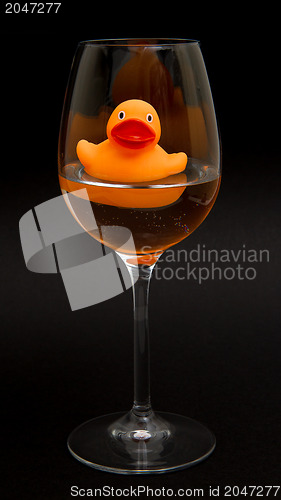 Image of Orange rubber duck in a wineglass