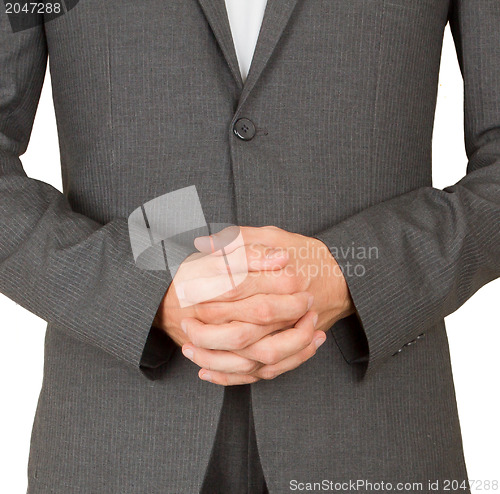 Image of Business man in grey suit praying