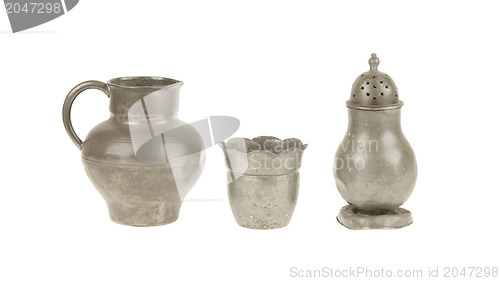 Image of Very old tin kitchen set full of scratches, isolated