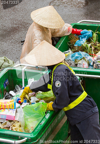 Image of DA LAT, VIETNAM - 28 JULY 2012: Government worker separates the 