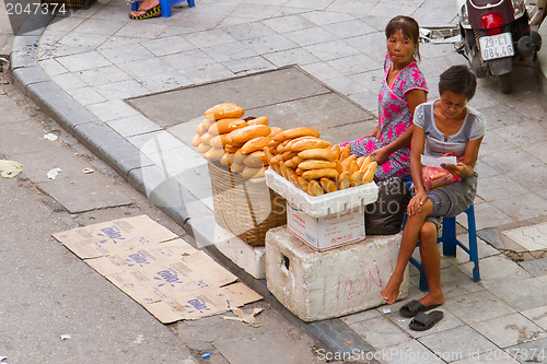 Image of HANOI, VIETNAM, 8 AUGUST 2012; Vietnamese street vendor selling 