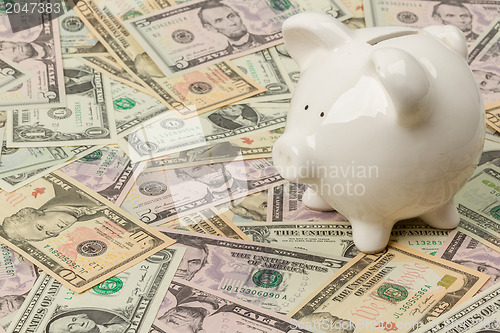 Image of Piggy bank on dollar bills