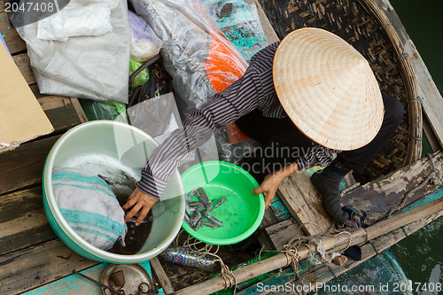 Image of HA LONG BAY, VIETNAM AUG 10, 2012 - Food seller in boat. Many Vi