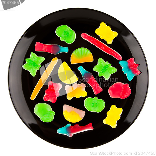 Image of Colorful candies in many different shapes isolated on a black pl