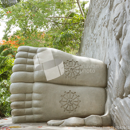 Image of Feet of a sleeping buddha, decorated with a swastika