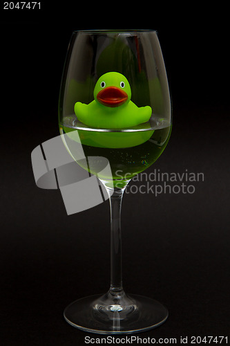 Image of Green rubber duck in a wineglass
