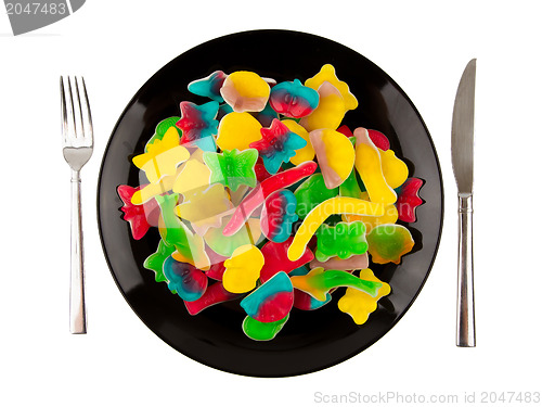 Image of Colorful candies in many different shapes isolated on a black pl