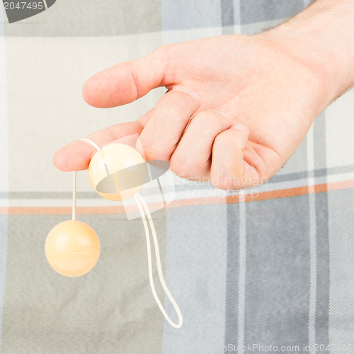 Image of Hand holding vaginal balls, isolated