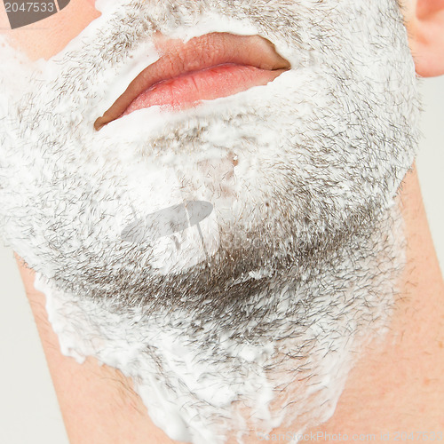 Image of Close-up of a young man shaving