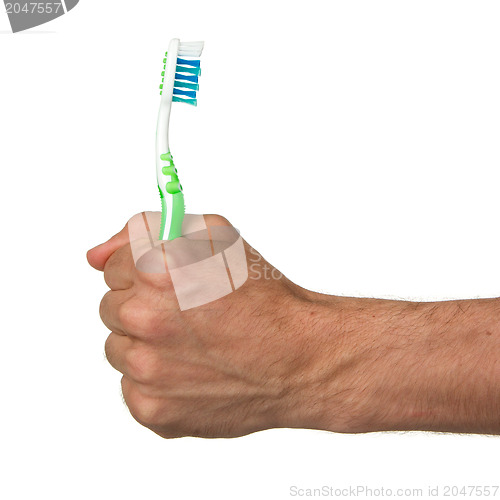 Image of Man holding a green toothbrush