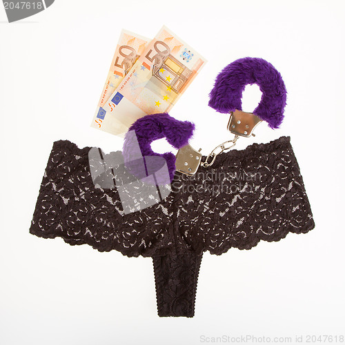 Image of Fluffy purple handcuffs, panties and money, prostitution
