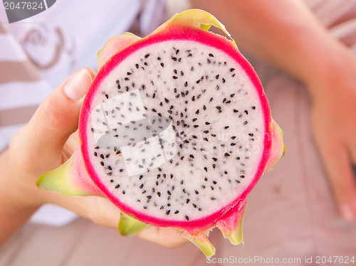 Image of Woman holding a dragon fruit