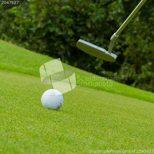 Image of Golf ball on front of a driver
