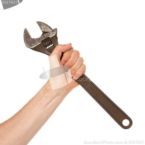 Image of Old rusted adjustable vector wrench in a hand