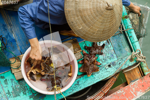 Image of HA LONG BAY, VIETNAM AUG 10, 2012 - Food seller in boat. Many Vi