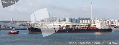 Image of Two tugboats manoeuvring an oil tanker in the dutch harbor of Ro