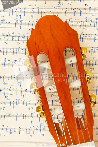 Image of Old music sheet and a guitar