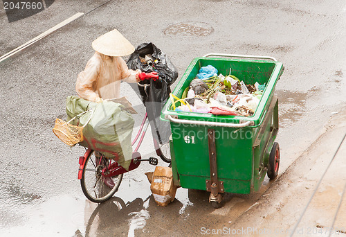 Image of DA LAT, VIETNAM - 28 JULY 2012: Government worker separates the 