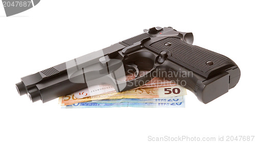 Image of Semi-automatic gun with some euro bills isolated