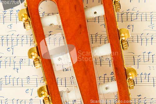 Image of Old music sheet and a guitar