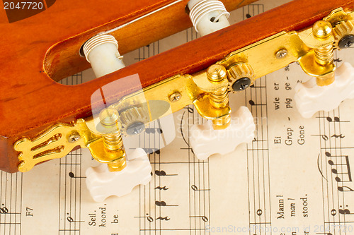 Image of Old music sheet and a guitar