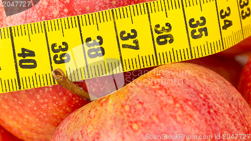 Image of Red apples with a yellow tape-measure