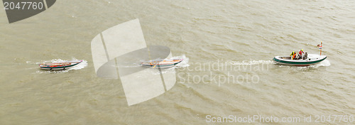 Image of Motorboat dragging some rowing-boats