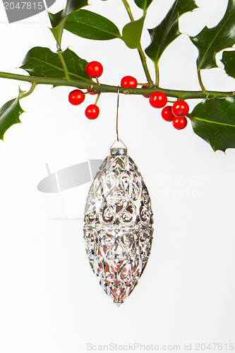 Image of Very old silver christmas ball hanging from a twig (butchers bro