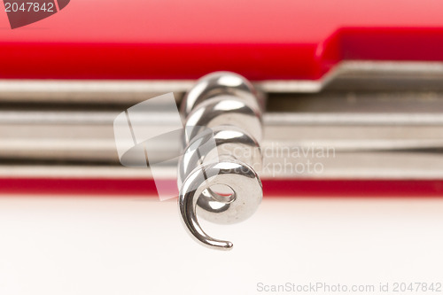 Image of Red swiss army knife isolated, focus on corkscrew