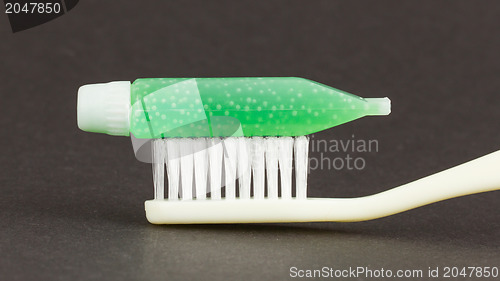 Image of Toothbrush and green toothpaste isolated