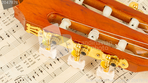 Image of Old music sheet and a guitar