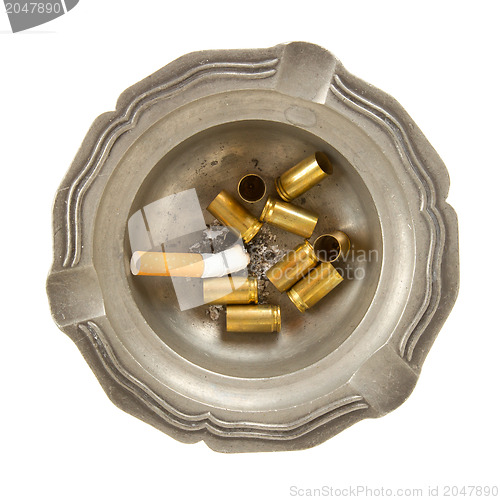 Image of Empty 9mm bullet casings in an old tin ashtray