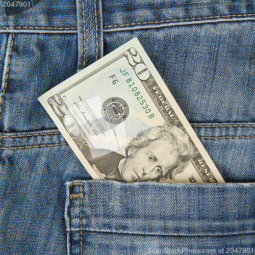 Image of Macro shot of trendy jeans with american 20 dollar bill