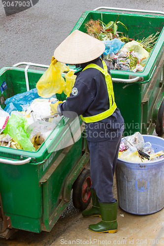 Image of DA LAT, VIETNAM - 28 JULY 2012: Government worker separates the 