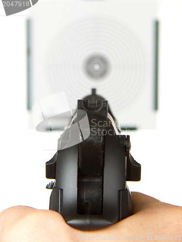 Image of Handgun aimed on a shooting target 